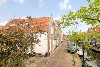 a street with buildings and cars parked on the street at CASASdeCASPER - Apartment Alkmaar in Alkmaar