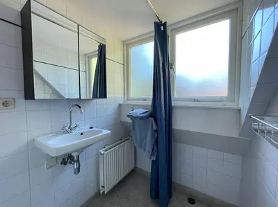a bathroom with a sink and a mirror at Bergense Duyn by Droomvilla in Bergen