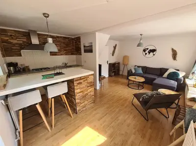 a living room and kitchen with a couch and a table at Have a nice stay! - North Sea Home in Noordwijk aan Zee
