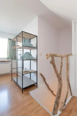 a shelf with shoes on it in a room at Have a nice stay! - North Sea Home in Noordwijk aan Zee