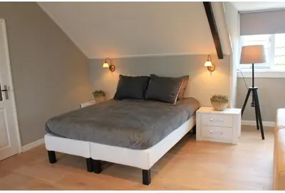 a bedroom with a large bed in a room at BNBSpanbroek in Spanbroek