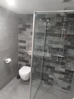 a bathroom with a toilet and a glass shower at BNBSpanbroek in Spanbroek