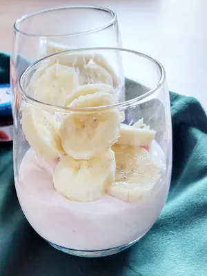 a glass cup filled with bananas and liquid at BNBSpanbroek in Spanbroek