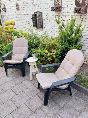 two chairs and a side table on a patio at BNBSpanbroek in Spanbroek