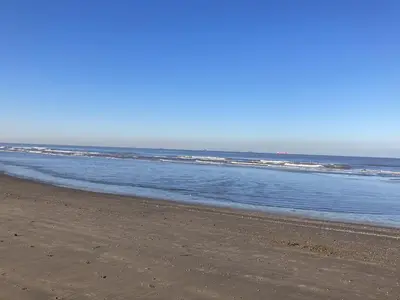an empty beach with the ocean in the background at Kustappartementenkatwijk 2F in Katwijk aan Zee