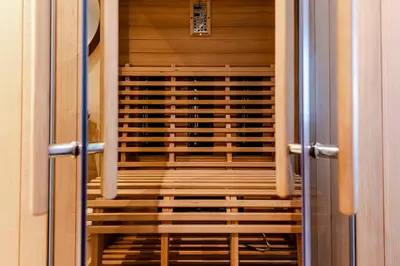 a door leading into a room with wooden racks at Kustappartementenkatwijk 2F in Katwijk aan Zee