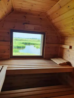 a sauna with a window in a wooden cabin at Walvisch van Ghyspe in Wormer