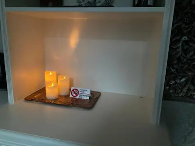 two candles sitting on a shelf in a room at GuesthouseOne in Haarlem