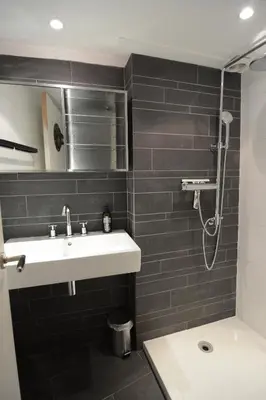 a bathroom with a sink and a shower at GuesthouseOne in Haarlem