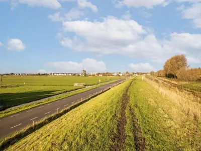 an empty road in the middle of a field at Beautiful houseboat with shared pool in Volendam
