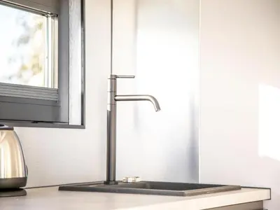 a kitchen sink with a faucet on a counter at Beautiful houseboat with shared pool in Volendam