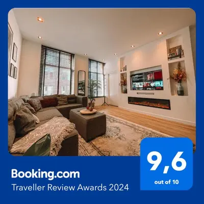 a living room with a couch and a tv at Coolest Apartments in Haarlem City - close to Beach and Amsterdam in Haarlem
