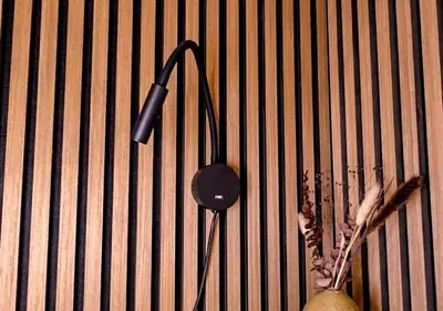 a black lamp hanging on a wall with a plant at Coolest Apartments in Haarlem City - close to Beach and Amsterdam in Haarlem