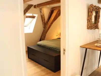 a bedroom with a bed and a drawer with a mirror at Coolest Apartments in Haarlem City - close to Beach and Amsterdam in Haarlem