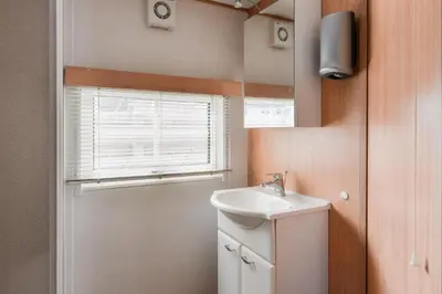a bathroom with a sink and a mirror at CHALET FOR 2 AT THE BEACH in Zandvoort