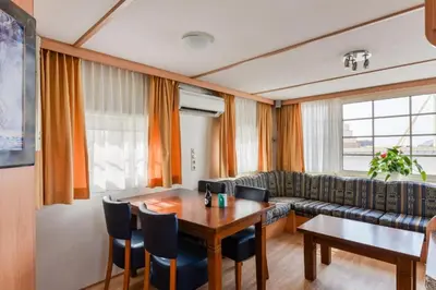 a living room with a table and a couch at CHALET FOR 2 AT THE BEACH in Zandvoort