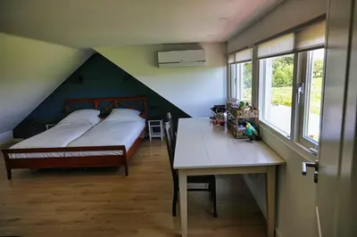a bedroom with a bed and a desk and a table at Natuurhuisje Gouderak in Gouderak