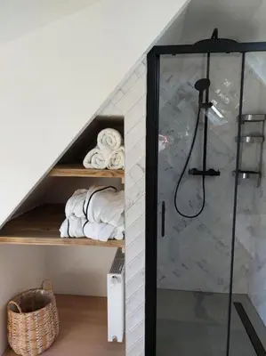 a bathroom with a shower in a attic at Tiny house Wakker in Eemnes