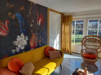 a living room with a yellow couch and a window at Tiny house Wakker in Eemnes