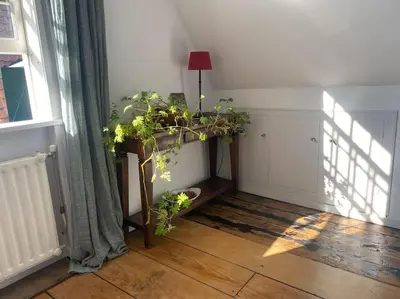 a room with a table with plants and a window at Characteristic two bedroom home in Edam
