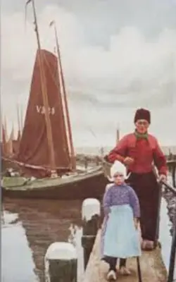 a woman and a child standing next to a boat at Characteristic two bedroom home in Edam