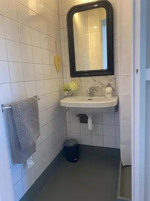 a bathroom with a sink and a mirror at Characteristic two bedroom home in Edam