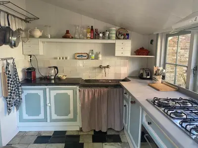 a kitchen with blue cabinets and a stove at Characteristic two bedroom home in Edam