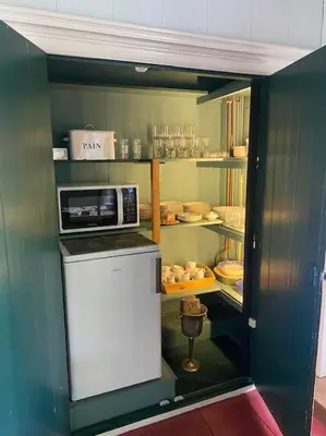 a small kitchen with a microwave on top of a refrigerator at Characteristic two bedroom home in Edam