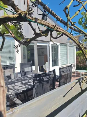 a wooden table and chairs on a patio at Rekerlanden 90 in Schoorldam
