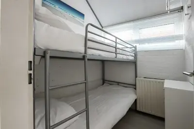 a room with two bunk beds and a window at Rekerlanden 90 in Schoorldam