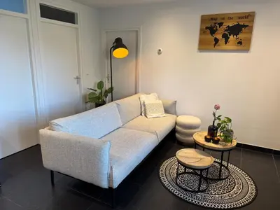 a living room with a couch and a table at Vakantiewoning aan de Kust 16 in Egmond aan Zee