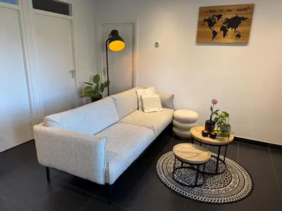 a living room with a couch and a table at Vakantiewoning aan de Kust 16 in Egmond aan Zee