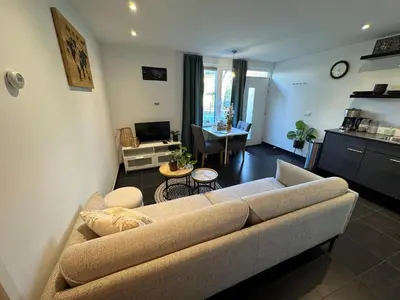 a living room with a couch and a table at Vakantiewoning aan de Kust 16 in Egmond aan Zee
