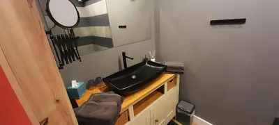 a bathroom with a black sink and a mirror at Beemster b&b in Zuidoostbeemster