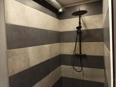 a bathroom with a shower with a shower head at Beemster b&b in Zuidoostbeemster