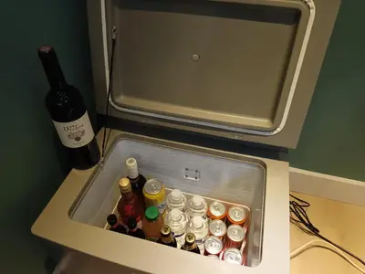 an open refrigerator with bottles of alcohol in it at Beemster b&b in Zuidoostbeemster