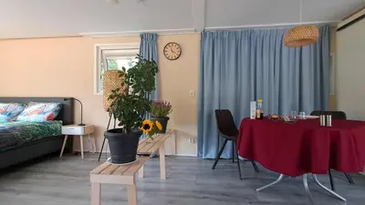 a living room with a table and a couch at Beemster b&b in Zuidoostbeemster