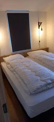 a bed in a bedroom with a large window at Rekerlanden 241 in Schoorldam