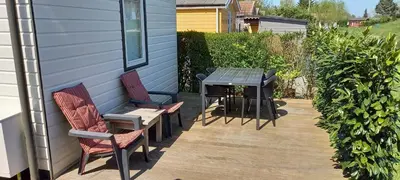 a patio with chairs and a table on a house at Rekerlanden 241 in Schoorldam