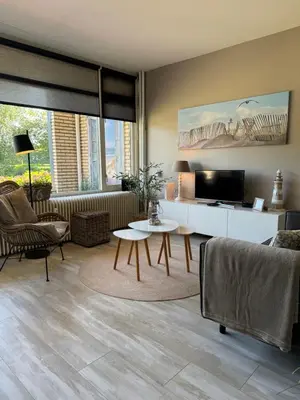 a living room with a couch and a table at Zee & Zand in Noordwijk