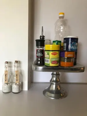 a shelf with spices and a bottle on it at Zee & Zand in Noordwijk