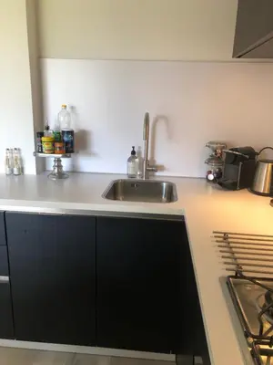 a kitchen with a sink and a counter top at Zee & Zand in Noordwijk