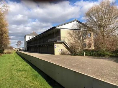 a large building with a staircase on the side of it at Zee & Zand in Noordwijk