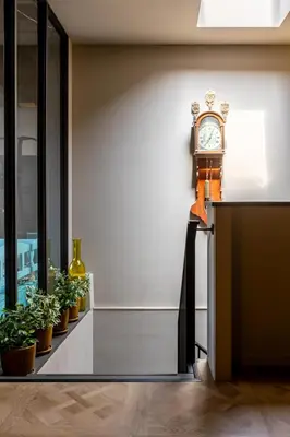 a clock sitting on a counter next to plants at ShortStay Gouda in Gouda