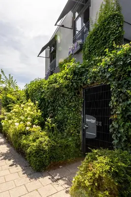 an ivy covered building with a gate in front of it at ShortStay Gouda in Gouda