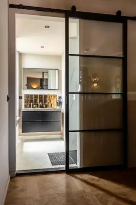 a glass door leading into a kitchen with a refrigerator at ShortStay Gouda in Gouda