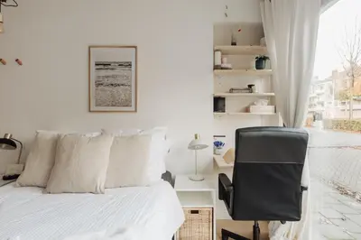 a bedroom with a bed and a desk and a chair at Luxurious Private Studio Amsterdam Zuid in Amsterdam