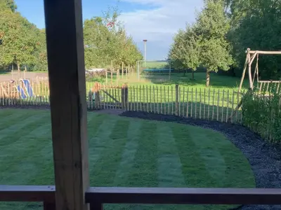 a view of a yard with a fence at De Porrel Polsbroek Unit met Privé Jacuzzi, Spa en Sauna in Polsbroek