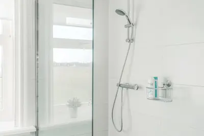 a shower with a glass door in a bathroom at Logies De Hooiberg in Lutjewinkel