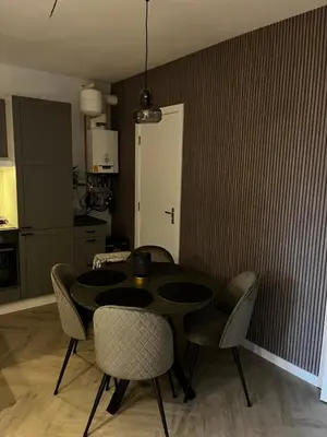 a kitchen with a table and chairs in a room at ‘T Singeltje in Leiden